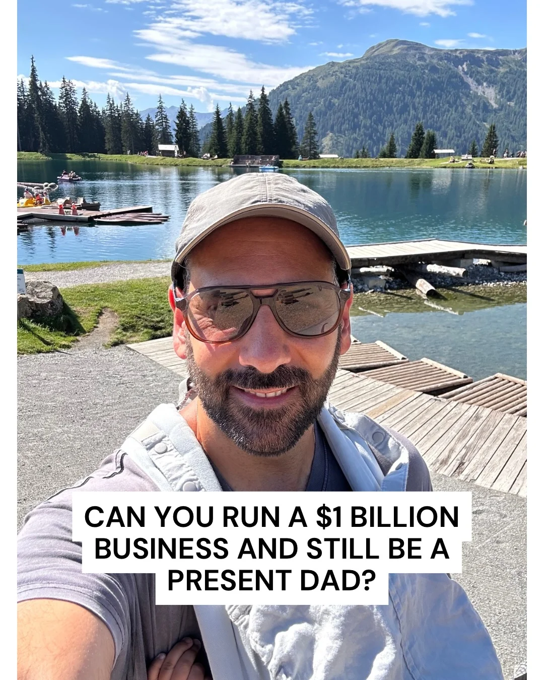 Bill beside a blue alpine lake, with mountains and trees behind him